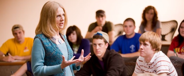 Instructor lecturing to a classroom of students